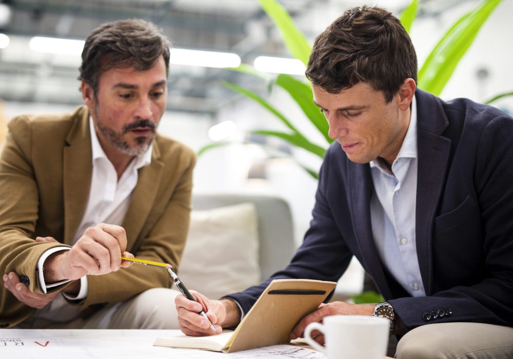 low-angle-male-coworkers-meeting-office