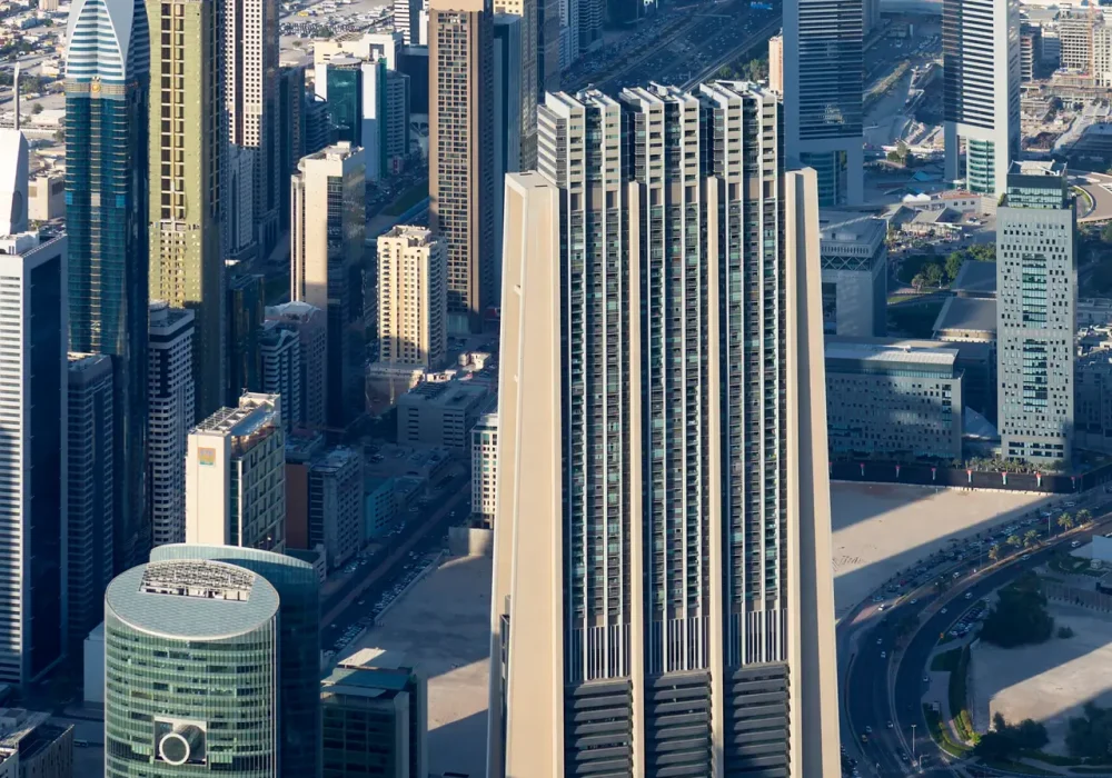 Vertical view of Dubai city from the top of a tower.