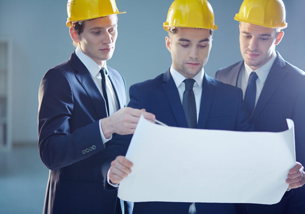 Closeup image of three constructors developing the business project