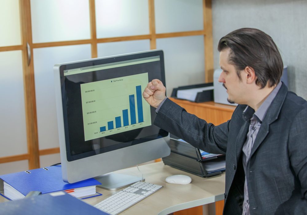 A young businessman working from his office - the concept of success